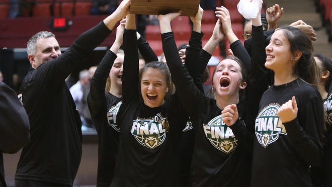The GlenOak girls basketball team celebrates its Division I regional championship win over Eastlake North earlier this year.