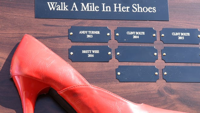 Walk A Mile In Her Shoes, an event to raise awareness to domestic abuse, presented its first Red Heel Awards Wednesday, May 25, 2016 to leading individual fundraiser Brett Wise and to top team fundraiser Divinity Homes.