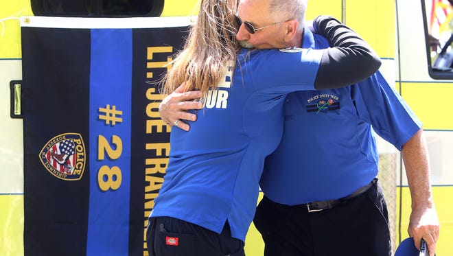 Gerard Franklin gets a hug from an EMT during the Police Unity Tour as cyclists pass and pay their respects near the site where his brother, retired Roxbury Lt. Joseph Franklin was involved in a fatal cycling accident during the Police Unity Tour last year. May 9, 2017, Far Hills, NJ