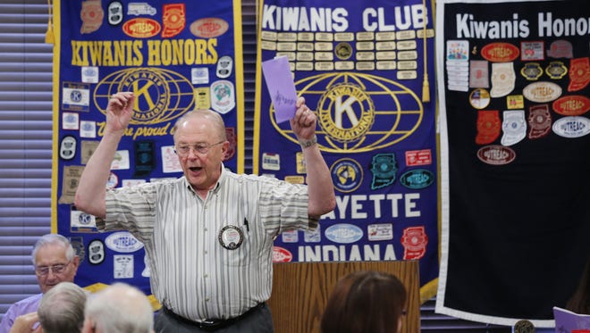 Roy Johnson leads members of Lafayette Kiwanis Club as they begin a meeting with a medley of songs.