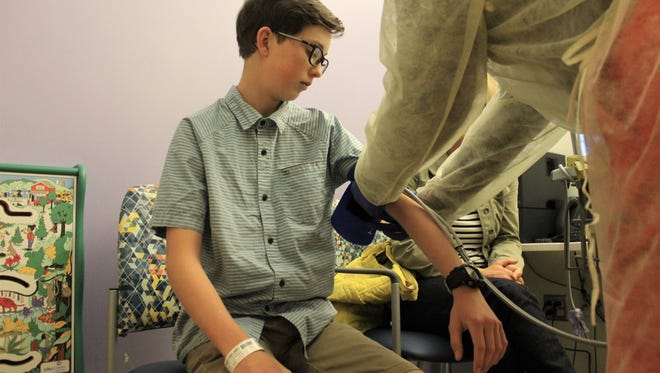 Noah Colbert, 12, gets his vitals taken at Colorado Children's Hospital Wednesday. Noah has cystic fibrosis. He has to come in at least quarterly for check ups. He participated in a clinical trial for Symdeko, which got FDA approved February 2018.