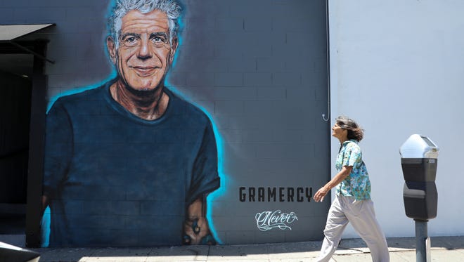 A recently painted mural in memory of culinary celebrity Anthony Bourdain gets the attention of a passerby on the wall of the Gramercy restaurant in Santa Monica, California. The tribute was created by street artist Jonas Never after Bourdain's death from suicide on June 8, 2018.