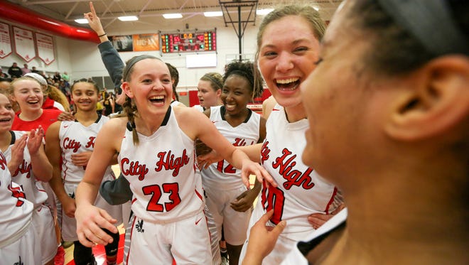 City High's Aubrey Joens (23) and her sister, Ashley, right, celebrate the Little Hawks' Class 5A regional final win over Bettendorf at City High on Tuesday, Feb. 20, 2018.