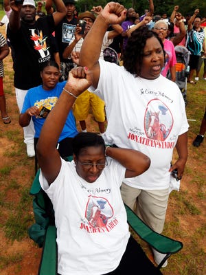 Frances Sanders, mother of Jonathan Sanders, seated, and his sister Nicole Holloway, respond during a remembrance and rally Sanders in Stonewall, Miss., Sunday, July 19, 2015. Sanders died after crossing paths with part-time Stonewall police officer Kevin Herrington, late July 8.