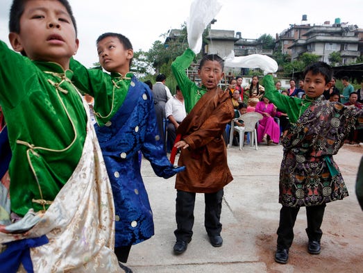 Tibetan boys dance during celebrations to mark the
