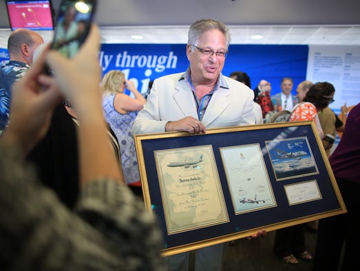 A passenger holds a special plaque commemorating several