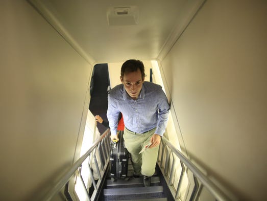 A passenger walks up the iconic stairs to the upper