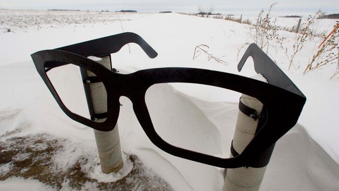 A giant pair of Buddy Holly eyeglasses marks the roadside spot that leads to the crash site north of Clear Lake.