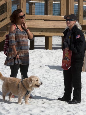 Susan Watson, the new animal control officer for Pensacola Beach, right, talks with Denise Andrews and her dog, Sunny, while on patrol at the dog park on the eastern end of Santa Rosa Island, Tuesday, Feb. 27, 2018.