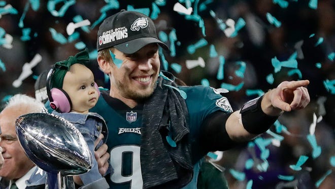 Philadelphia Eagles' Nick Foles holds his daughter, Lily, after beating the New England Patriots in the NFL Super Bowl 52 football game Sunday, Feb. 4, 2018, in Minneapolis.
