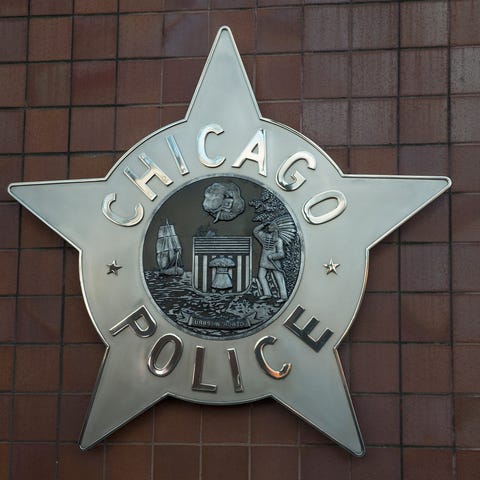 A Chicago police badge hangs in front of the City 
