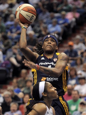 Indiana Fever guard Sydney Carter, top, shoots over Minnesota Lynx forward Maya Moore, below, during the second quarter of a WNBA basketball game Sunday, June 22, 2014, in Minneapolis. (AP Photo/Tom Olmscheid)