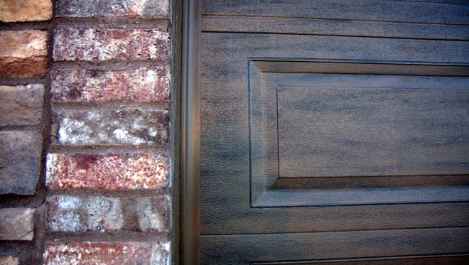 This closeup of a garage door shows the wood grain faux finish that Fall River Designs does.