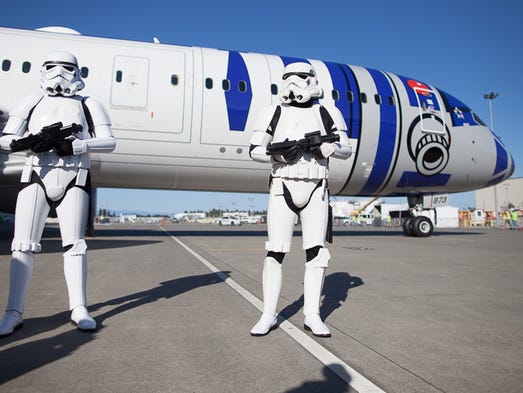 Storm Troopers guard a Star Wars, R2-D2-themed Boeing
