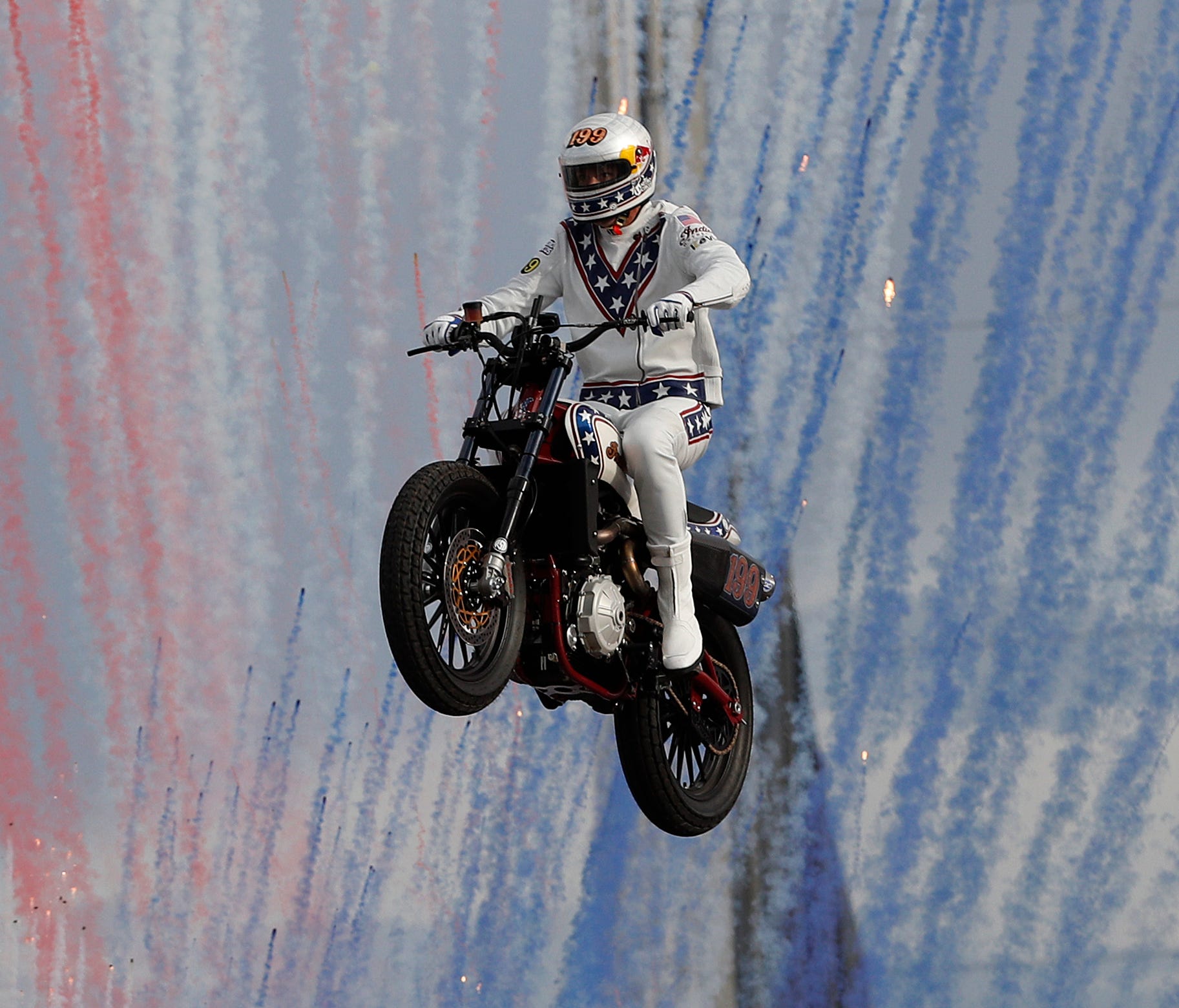 Travis Pastrana jumps a row of crushed cars on a motorcycle in Las Vegas.