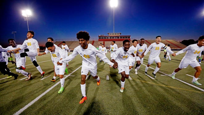 Soccer players from Margaret Long Wisdom High School in Houston celebrate an undefeated season.