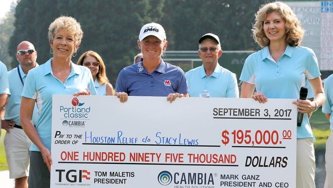Stacy Lewis is presented with the winner's check on the 18th green after her victory in the LPGA Cambia Portland Classic at Columbia Edgewater Country Club.