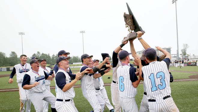 West Bend West players hoist the trophy and celebrate a state championship