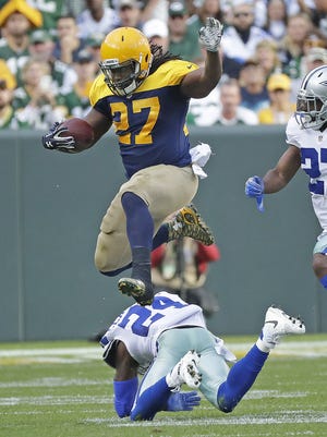 Packers running back Eddie Lacy leaps over Cowboys cornerback Morris Claiborne in Green Bay's loss to Dallas at Lambeau Field.