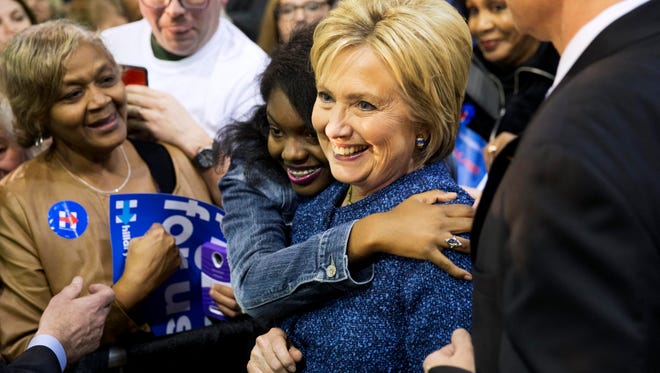 Democratic presidential candidate, Hillary Clinton, right, is embraced by an audience member while posing for a photo at a campaign event at Miles College Saturday, Feb. 27, 2016, in Fairfield, Ala. (AP Photo/David Goldman)  