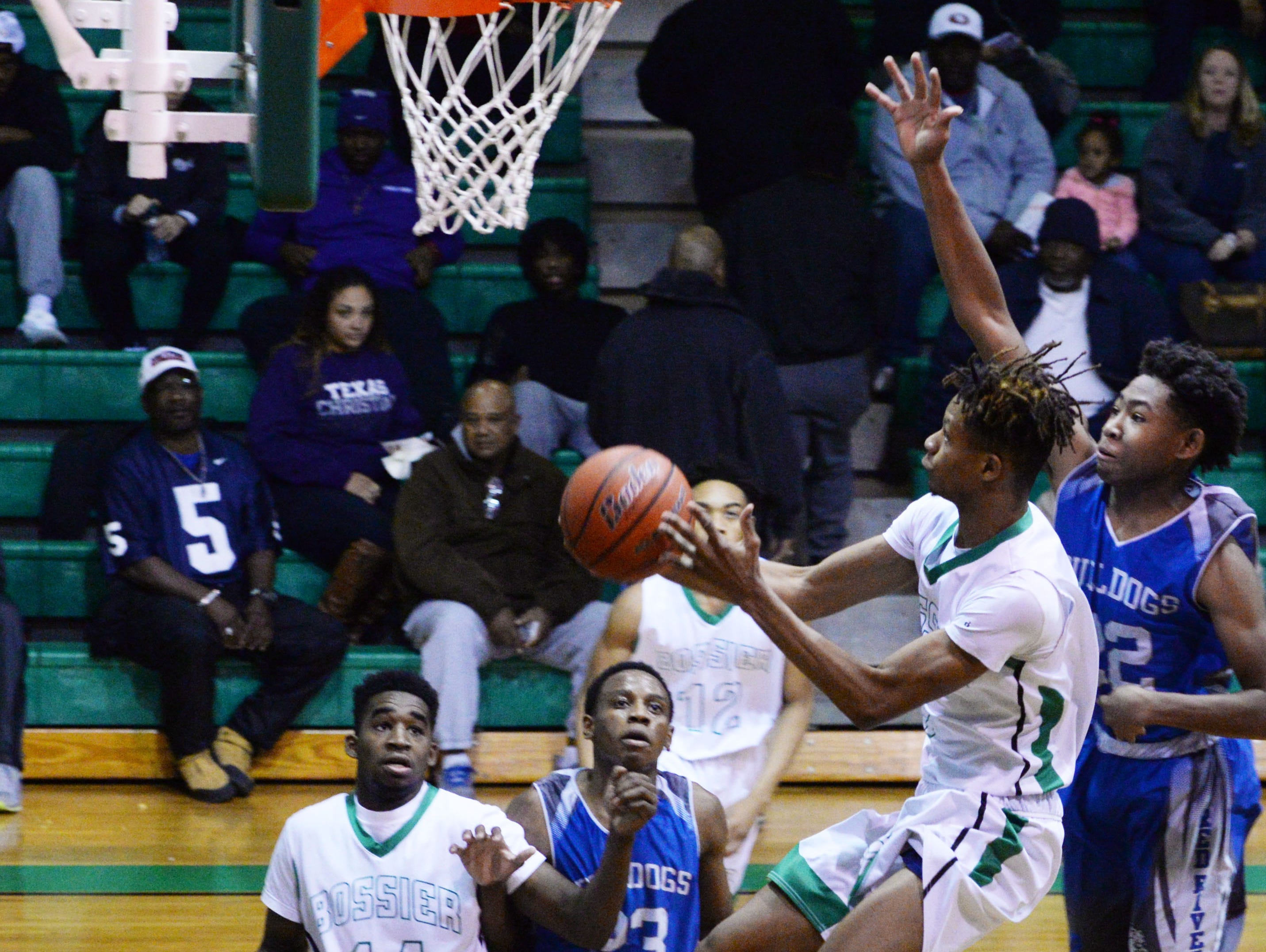 Bossier's TyBo Wimberly tries to get the ball in the basket during their game against Red River Friday evening.