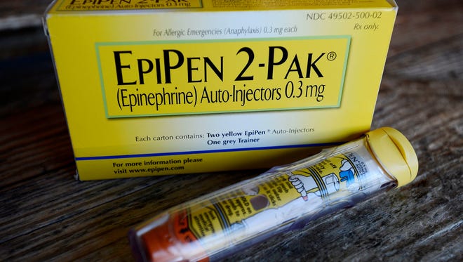 This Oct. 10, 2013, file photo, shows an EpiPen epinephrine auto-injector, a Mylan product, in Hendersonville, Texas. Mylan, now in the crosshairs over severe price hikes for its EpiPen, said Thursday, Aug. 25, 2016, it will expand programs that lower out-of-pocket costs by as much as half.