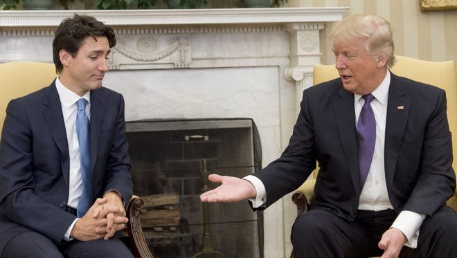 This file photo taken on February 13, 2017 shows U.S. President Donald Trump and Canadian Prime Minister Justin Trudeau  during a meeting in the Oval Office of the White House in Washington, D.C.