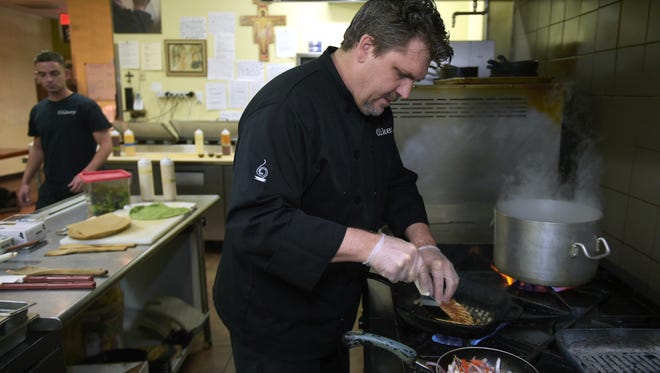 Chef Brett Swayn of The Cookery cooks a meal for a customer at the 12th South restaurant on Wednesday, Dec. 7, 2016. In addition serving breakfast, lunch and dinner to the public, The Cookery trains formerly homeless people to be cooks through a seven month program. So far 13 culinary students have graduated.
