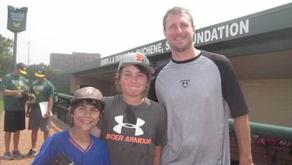 Nathan Murray, left, and Max Murray, center, pose for a photo with Max Scherzer during the boys'  trip to Detroit last summer.