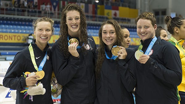 Allison Schmitt, second from left, celebrates with teammates after winning the 4x200 meter freestyle relay at the Pan Am Games on Thursday.