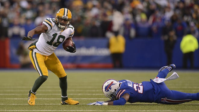 Green Bay Packers receiver Randall Cobb (18) shakes off Buffalo Bills safety Aaron Williams (23) after making a catch in the fourth quarter during Sunday's game at Ralph Wilson Stadium in Orchard Park, N.Y.