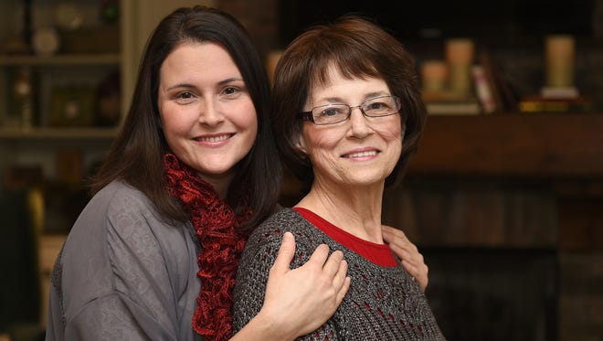 Rebecca Larson, left,  with her mother, Kathy Canosa, at Larson's Goodletsville home on Monday, Jan. 4.  Larson and her sister donated their own hair so their mother could have a real-hair wig to wear after her own hair loss from chemotherapy to treat leukemia.
