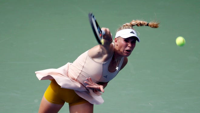 Caroline Wozniacki of Denmark serves to Maria Sharpova of Russia during their match at the U.S. Open.