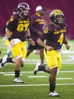 ASU players Christian Westerman, left, Tommy Hudson and Demario Richard run during warmups in the Verde Dickey Dome at practice, Tuesday morning, August 18, 2015.