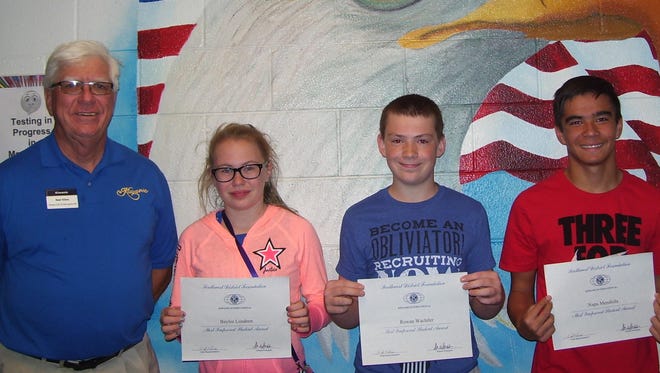 Holloman Middle School pictured left to right: Kiwanis Club member Ned Kline, Holloman students Baylee Lundeen, Rowan Wachtler and Napu Mendiola.