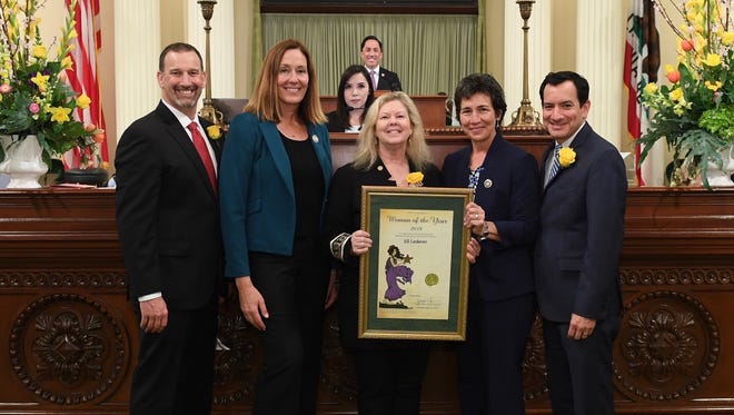 Local business leader Jill Lederer, center, is honored by Assemblywoman Jacqui Irwin, second from left, during the annual Woman of the Year celebration in Sacramento on Monday.