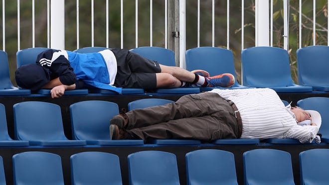 Spectators sleep during the Dressage Grand Prix event on Day 7 of the Rio 2016 Olympic Games.