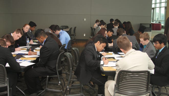 Several students focus on their business pitches before going on stage during last year's Michigan DECA Conference.