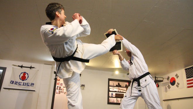 Valeria Norgord completes a breaking taekwondo exercise.