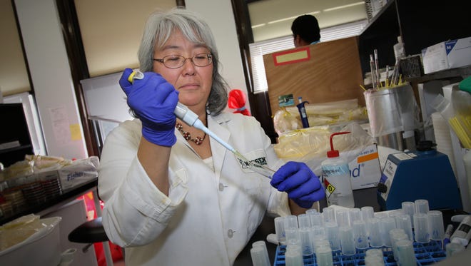 Neogen scientist Debra Foti tested egg samples for Salmonella at the company's Allen Street laboratory in 2010. Neogen recently acquired a Brazilian pesticide manufacturer.