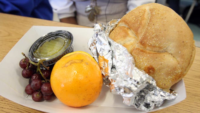 A chicken parmesan sandwich with pickles, grapes and an orange served for lunch in the cafeteria at Riverside High School in Yonkers.