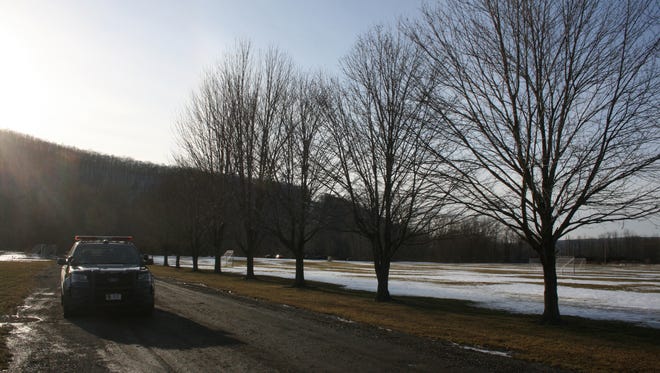 A New York State Police vehicle guards the entrance to Senator William T. Smith Boat Launch in Big Flats on Feb. 14.