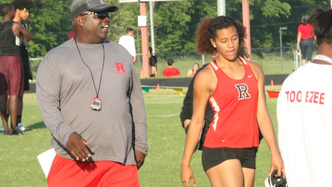 Rossview coach Ronnie Hudson talks with one his athletes during the Section 3 North Sub-Sectional track meet Tuesday at West Creek High School.