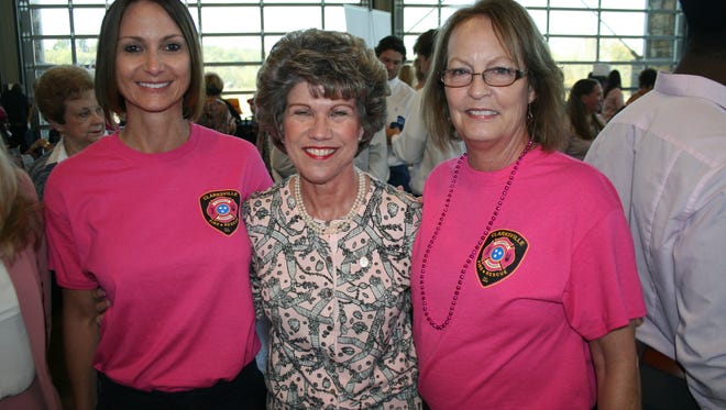 Mayor Kim McMillan congratulates Gina Mills (left) and Susan Harris for their work selling pink Clarksville Fire Rescue T-shirts, raising a $2,500 donation to the YMCA's ABC Program.