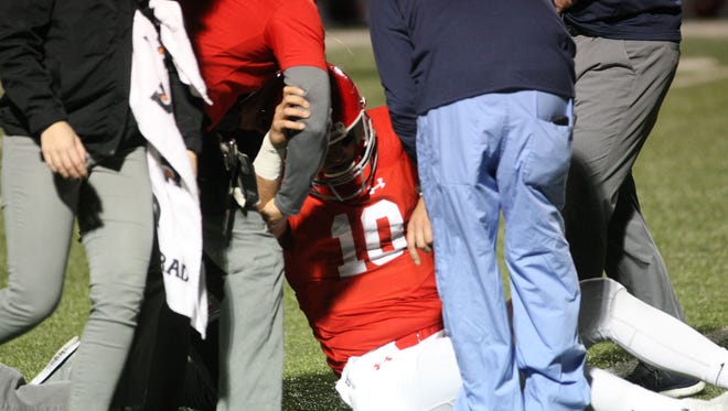 Brentwood Academy quarterback Gavin Schoenwald sat on the field as trainers attended to him after he injured his left shoulder early in the third quarter against McCallie in the Division II, Class AAA state semifinal game Friday night.