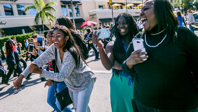 Paradegoers cheer during the Dr. Martin Luther King Jr. parade along Fifth Avenue South in downtown Naples on Monday, Jan. 15, 2018.