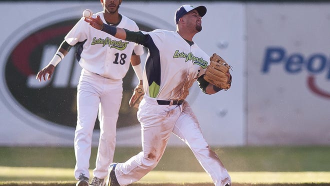 Vermont Lake Monsters third baseman Javier Godard, center, makes a throw to first base against Brooklyn during Wednesday night's game at Centennial Field.