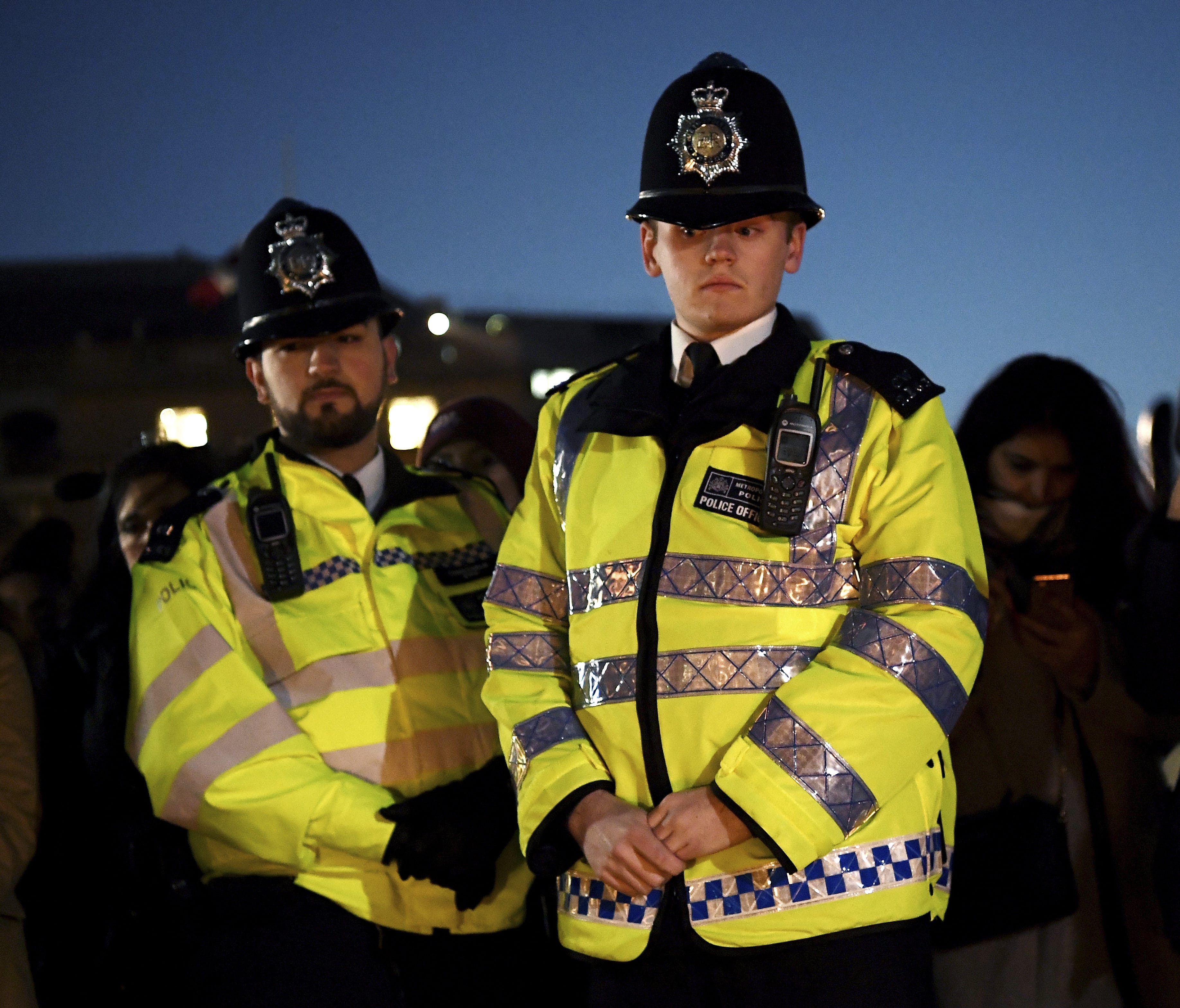 Two Metropolitan Police officers look on during a candlelit vigil at Trafalgar Square on March 23, 2017 in London.