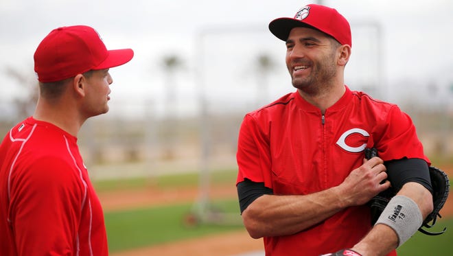 Reds first baseman Joey Votto (right) jokes with catcher Devin Mesoraco at spring training in Goodyear on Feb. 28.