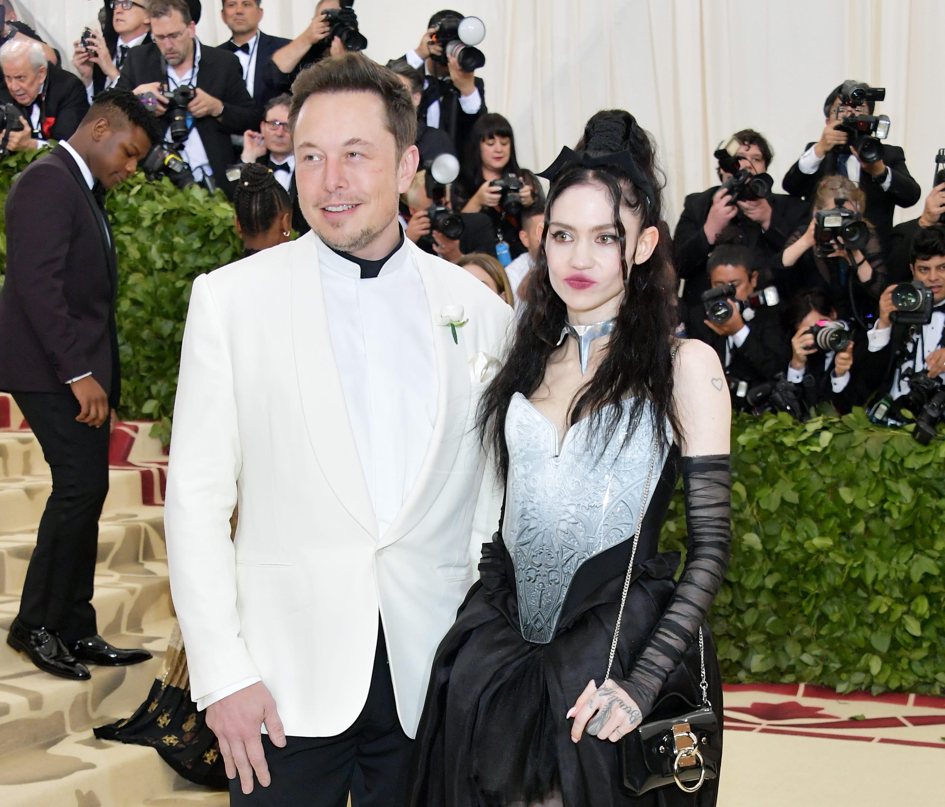 Elon Musk and Grimes arrive at the Met Gala together, making their relationship red-carpet official.